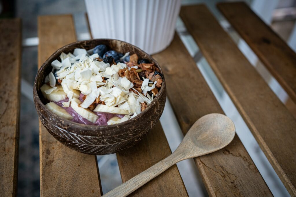 Tropical bowl with bananas, coconut, and granola for a Healthy Breakfast in Brussels.