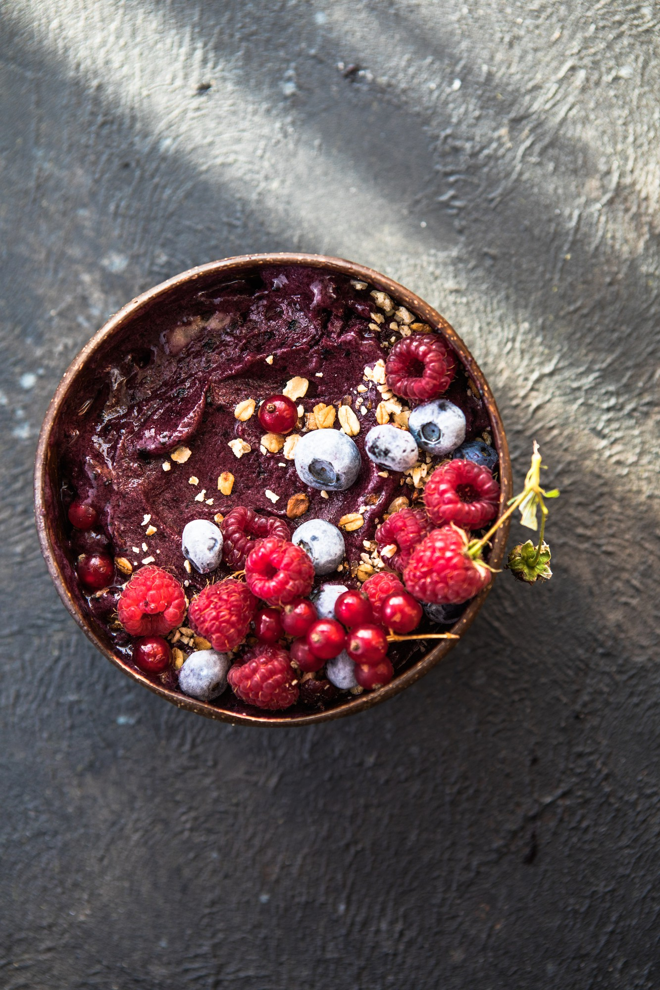 Rustic-style açaí bowl with red berries and granola – antioxidant-packed organic meal