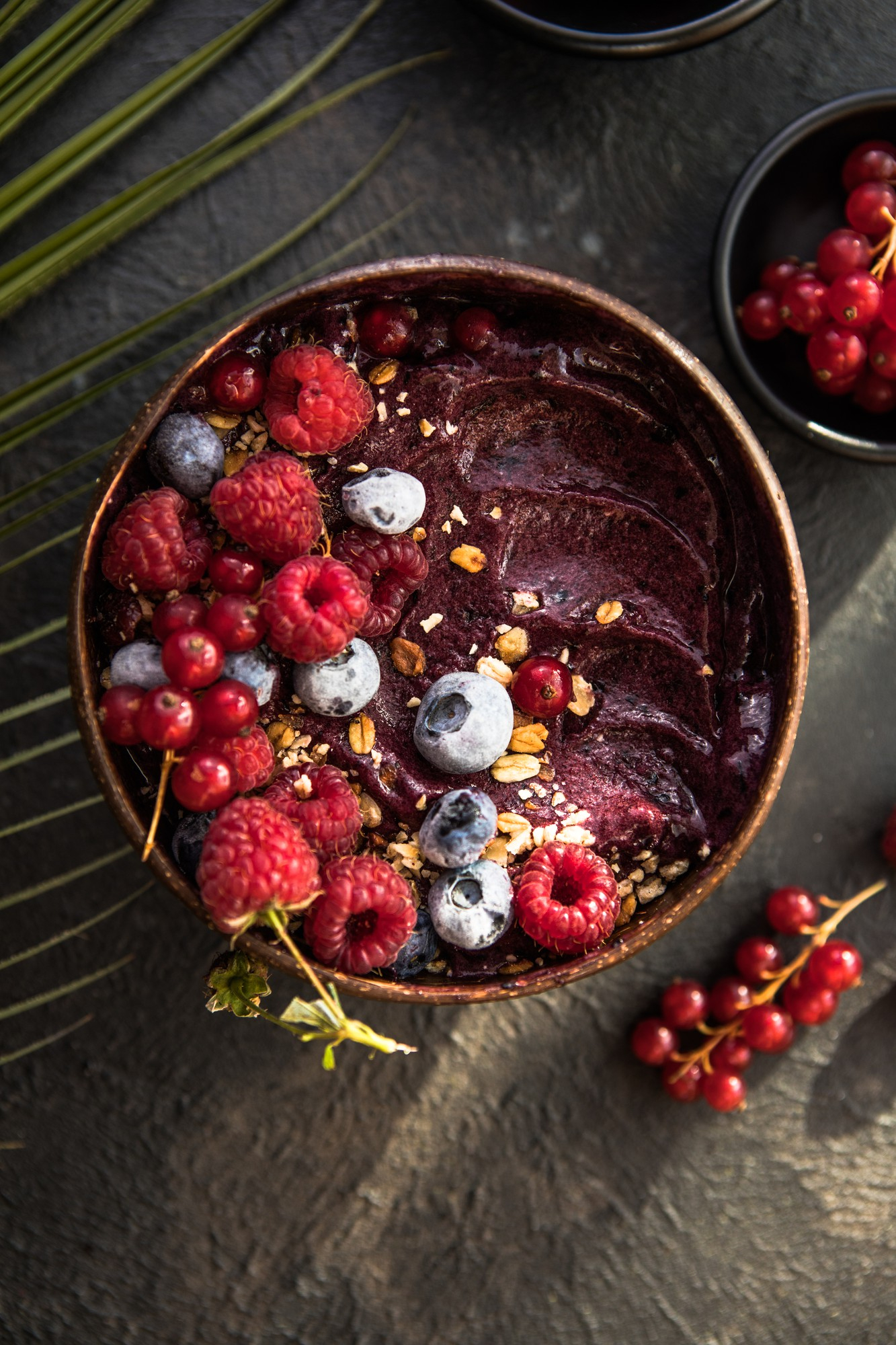 Artisanal açaí bowl with raspberries, currants and oats – tropical plant-based superfood