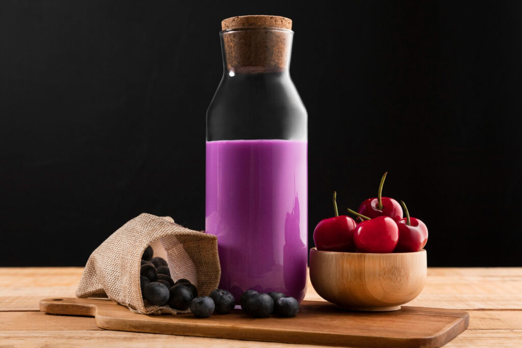 Purple antioxidant smoothie bottle with fresh berries meeting certification bio food standards for healthy beverage production