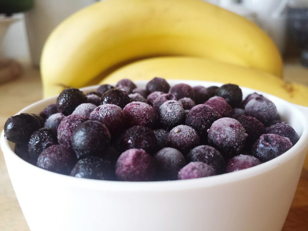 White bowl filled with frozen mixed berries showcasing the preservation of açaí antioxidants in frozen fruit